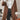 Women's brown suede winter coat with shearling lining, featuring a stylish design with a prominent collar, long sleeves, and a fitted waist, highlighting luxurious fashion and elegance.