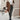 Women's brown shearling-lined suede winter coat, featuring long sleeves and a cozy, luxurious design, suitable for stylish cold-weather wear.