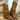 Women's brown suede fringe cowboy booties with a fashionable design, showcasing classic Western style for fall fashion.