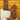 Women's brown suede fringe cowboy booties displayed on a model wearing a dress, highlighting the stylish fringe detail and rich brown color, perfect for fall fashion.