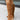 Women's brown suede slouchy knee-high boots in a bohemian fall style, showcasing the soft suede texture and relaxed fit around the leg.