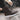 Women's brown waterproof insulated high-top snow boots displayed outdoors, showcasing their stylish design suitable for winter weather.