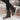 Women's brown waterproof insulated high-top snow boots being worn, showcasing their stylish design and knee-high coverage, set against an outdoor backdrop with trees.