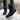 Women's brown waterproof insulated high-top snow boots worn by a person standing outdoors in the snow near a tree. The boots are designed for cold weather and provide style and protection.