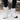 Brown waterproof insulated stylish high-top women's snow boots on a person standing, with a focus on the footwear and textile material.