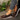 Women's brown wedge loafers styled as casual sneakers, worn by a person dressed in a fashionable outfit featuring a dress and blazer.