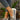 Women's brown wedge loafers styled as casual sneakers, shown in a natural setting.