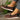 Women's brown wedge loafers styled as casual sneakers, showcasing the shoe's design with a moderate heel height and a fashionable appearance.