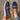 Women's stylish brown wedge loafers worn with jeans, showcasing a casual look.