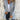 Women's camel coat made of lightweight wool, featuring a casual chic design perfect for fall. The coat has a structured collar, long sleeves, and a tailored fit around the waist, blending elegance with comfort. The neutral hue complements a variety of outfits, adding versatility to wardrobe choices.