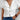 Women's white V-neck button-front short sleeve blouse worn with jeans.