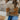Women's color-blocked cozy knit sweater featuring a trendy tri-color design with sections of white and other complementary shades. The sweater showcases long sleeves and a comfortable fit over the shoulders and neck, creating a stylish look suitable for various body types.