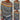 Women's colorful striped knit sweater with a stylish boat neck pullover, featuring a combination of white, black, grey, and yellow stripes.