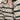 Women's cream and burgundy striped puff sleeve sweater with a round neck, featuring a stylish and cozy design perfect for autumn.