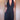 Women's elegant black halter neck jumpsuit featuring a V-neck design, showcasing a sleek sheath style with defined waist and thigh areas, perfect for formal or party occasions.
