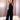 Women's elegant black halter neck jumpsuit featuring a V-neck design, showcasing fitted waist and flowing pant legs suitable for party or formal occasions.