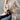 Elegant cream wool oversized winter coat for women, showcasing fall fashion style. The coat features a refined design with a soft shoulder line and a structured neck. The model is wearing sunglasses and a white dress shirt underneath, perfectly complementing the fashionable outerwear.