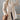 Elegant cream wool oversized winter coat worn by a woman, showcasing fall fashion style. The coat complements denim jeans and shoes, accessorized with sunglasses, highlighting a chic and modern look.