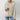 Women's cozy winter hoodie with fur-lined interior, featuring a cable-knit design in a neutral grey and beige color palette, long sleeves, and a comfortable collar.
