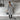 Women's knee-length gray wool coat with collar, button details, and long sleeves, styled for urban fashion.