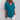 A woman wearing a sea blue, 5XL, short sleeve, V-neck linen tunic, styled casually with loose fit.
