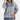 Women's grey plaid fleece sweater with a cozy high neck, featuring long sleeves and a soft textile texture.