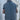 Women's grey sleeveless quilted puffer vest, lightweight and perfect for winter layering, shown on a model wearing a blue T-shirt and denim jeans.