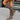 Women's grey suede over-the-knee boots featuring a stylish buckle detail, shown on a model wearing the boots with high heels, highlighting the knee and thigh area.