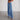 Women's high-waisted wide-leg jeans with vintage style and frayed hem in electric blue denim, showcasing a fashionable design with emphasis on the waist and thigh areas.