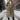 Women's insulated taupe hooded puffer coat featuring a long design, with a plush fur-trimmed hood and full-length sleeves, ideal for winter weather.