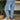 Women's light-wash high-waist ankle-length relaxed fit jeans with a casual fashion look, shown paired with black shoes against a white background.