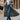 Women's long grey coat with a stylish urban chic design, featuring a tailored fit with defined shoulders, a high neck, full sleeves, and a waist-cinching silhouette.