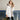 Women's luxury white puffer jacket with fur hood, featuring sleeves and a collar, designed to keep warm during winter, made from natural materials.