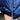 Women's metallic blue hooded puffer jacket displayed on a hanger against a plant background, highlighting its insulated and lightweight design with long sleeves and a waist-length cut.