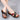 Women's multicolor wedge sandals with open toe design, shown worn on feet, paired with a dress.