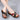 Women's multicolor wedge sandals, comfortable open toe slip-on, featuring pink accents, worn on a model's feet.