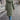 Women's olive quilted long winter coat, eco-friendly puffer jacket, featuring a waist-length design with long sleeves and knee-length hem, accented with a fur-lined hood.