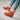 Women's orange suede ankle boots featuring a sherpa lining and chunky heel, shown on a person’s feet.