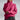 A woman wearing an oversized pink cashmere turtleneck knit sweater, showcasing the sweater's long sleeves and relaxed fit.