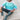 Women's oversized pastel striped knit sweater in aqua and purple tones, featuring long sleeves.