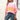 Women's oversized pastel striped knit sweater in aqua and purple tones, featuring a cozy pullover design with long sleeves. The sweater displays a relaxed fit, ideal for pairing with jeans, set against a casual indoor backdrop.