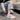 Women's pastel chunky sneakers featuring a stylish multi-color design, worn with visible lower legs and knees, embodying a blend of urban fashion and comfort.