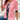 Woman wearing a pink cardigan over a white floral blouse, showcasing casual spring fashion with arm and hand visible.