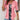 Woman wearing a pink cardigan over a floral blouse, styled for casual spring fashion.