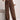 Women's plush brown fleece lounge pants with a cozy wide-leg design, shown in a relaxed pose.