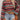 Women's colorful bohemian striped knit crop top featuring long sleeves and a retro design.