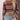 Women's retro striped knit crop top in a colorful bohemian style, featuring vibrant stripes and a cozy sweater texture, paired with white shorts.