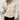 A women's white insulated puffer jacket featuring a ribbed high collar.