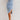 Women's sleeveless light wash denim bodycon midi dress, featuring a form-fitting design with a sheath style, highlighting the arms and neckline.