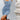 Sleeveless light wash denim bodycon midi dress worn by a woman standing, showcasing a fitted silhouette with emphasis on waist and shoulder details.